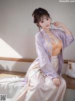 艾玲儿 - 星眸映古之繁华世界の诱人佳人 Set 1 20230726 Part 15 A woman in a purple and orange dress sitting on a bench.